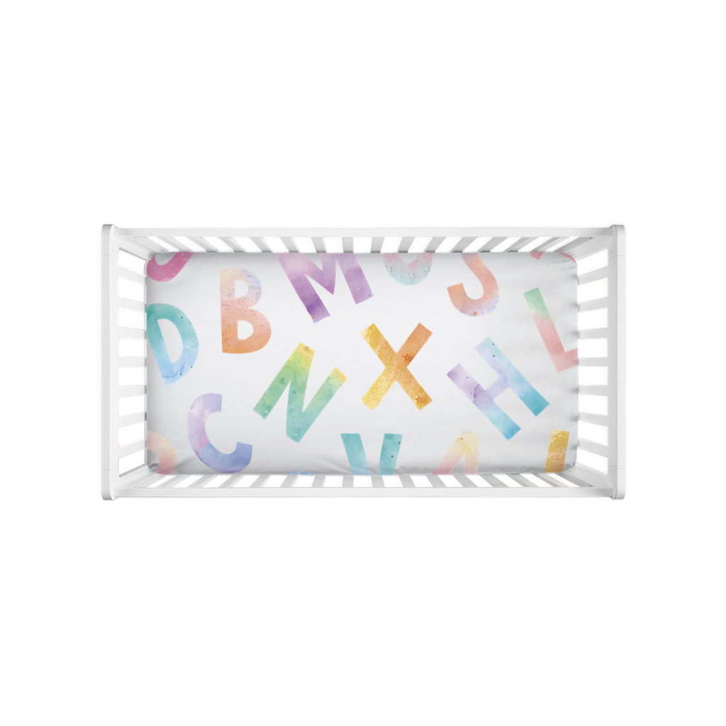 Crib sheet design with letters of the alphabet with watercolor effect.
