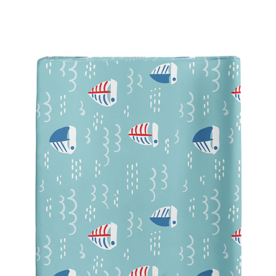 Close up of sailboat pattern on blue ocean doodle background.