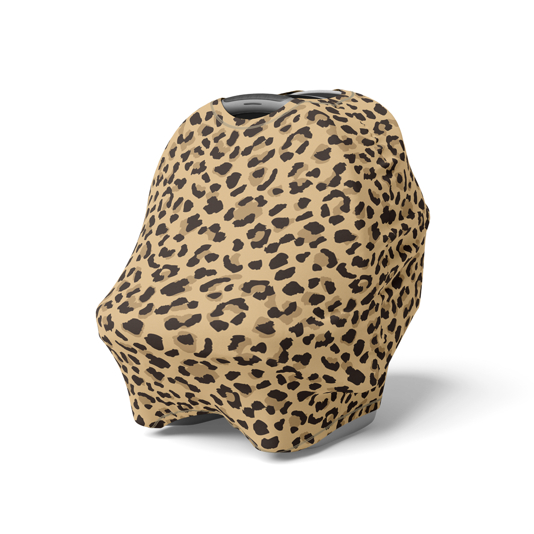 Angled view of car seat with leopard print multi-use nursing cover.