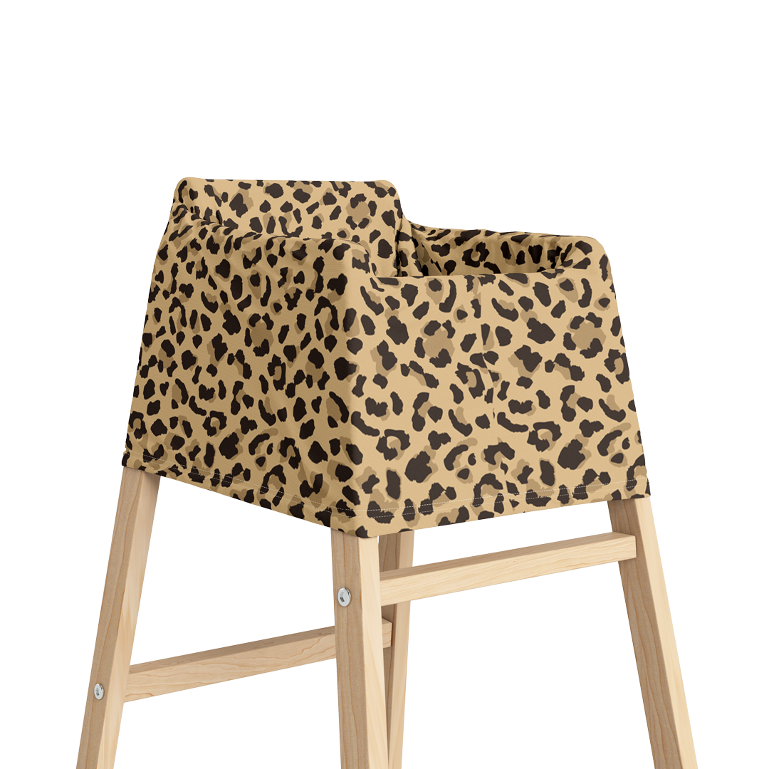 Angled view of baby high chair with leopard print multi-use nursing cover.